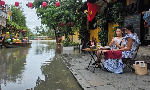 Du khách nước ngoài thích thú lội nước, 'săn' ảnh phố cổ Hội An ngày ngập lụt